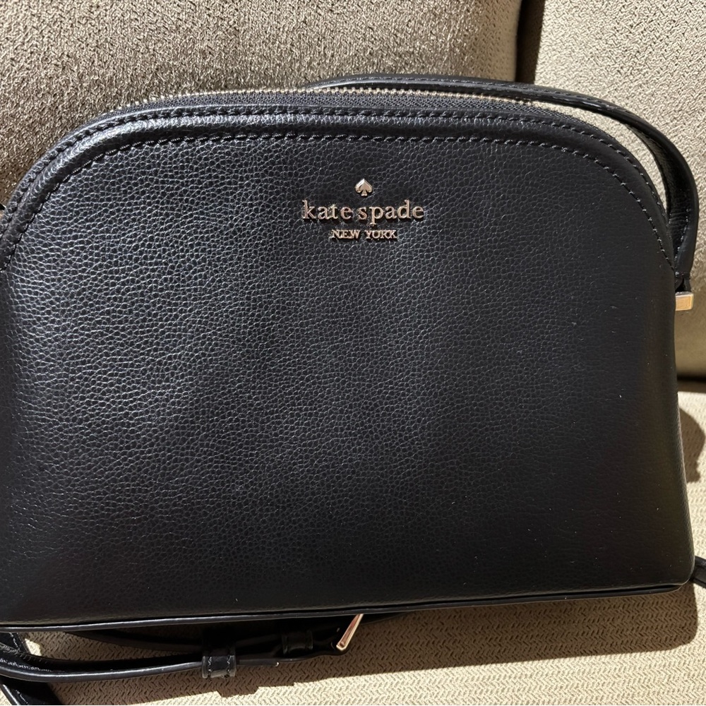Kate Spade Black Leather Crossbody Bag, slip pocket inside and outside.